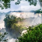 The waterfall at Iguazu National Park surrounded by forests covered in the fog under a cloudy sky
